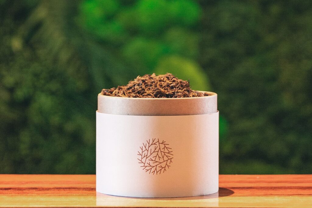 small container of human composting soil sitting on counter