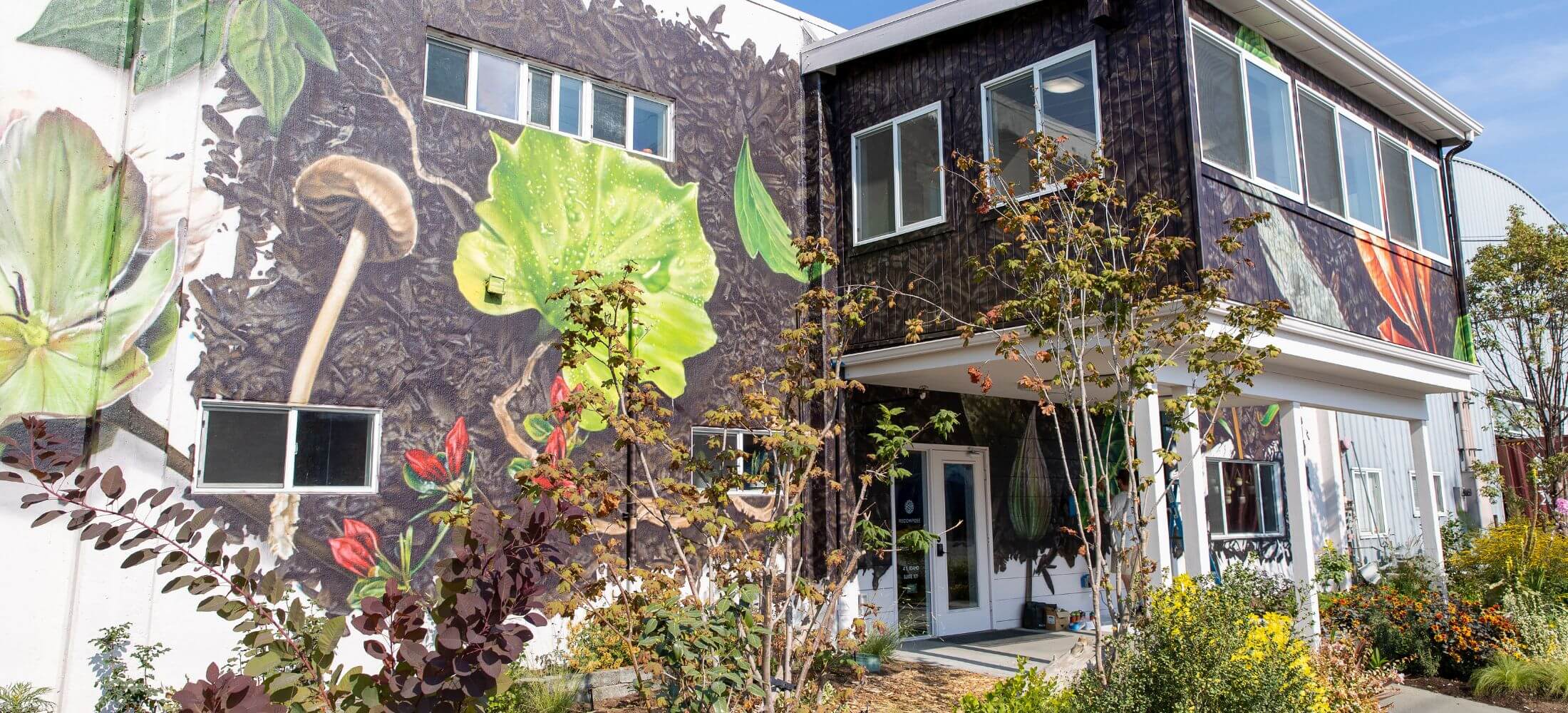 Exterior of recompose seattle building with mural of nature on building