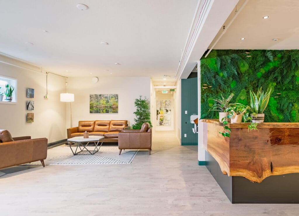 reception area of funeral home with sofas and green wall