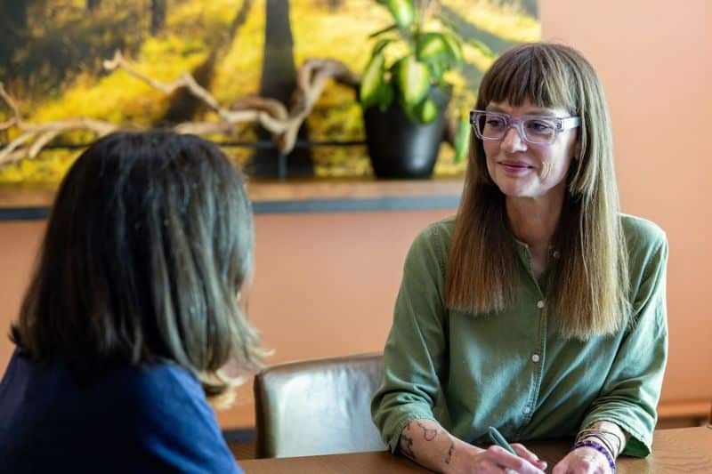 funeral director talking to a client at a funeral home