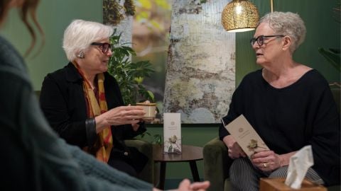 two women talking in a funeral home