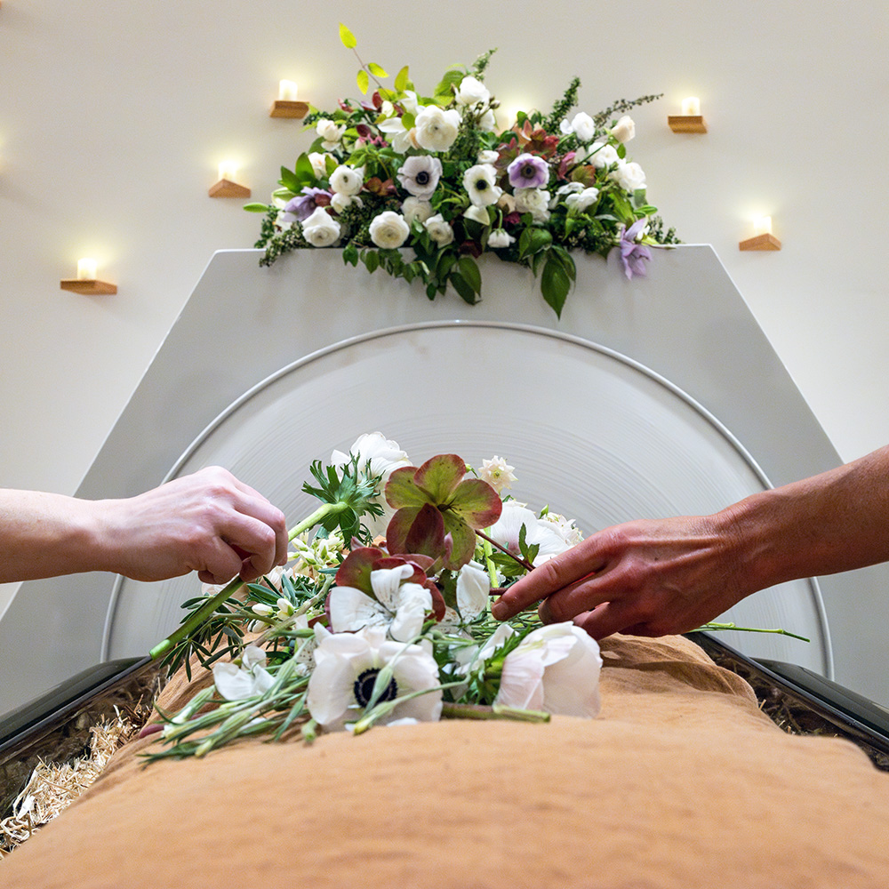 hands over a vessel with flowers