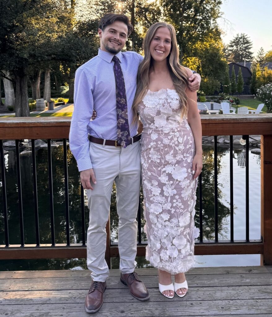two people dressed up standing next to each other outside